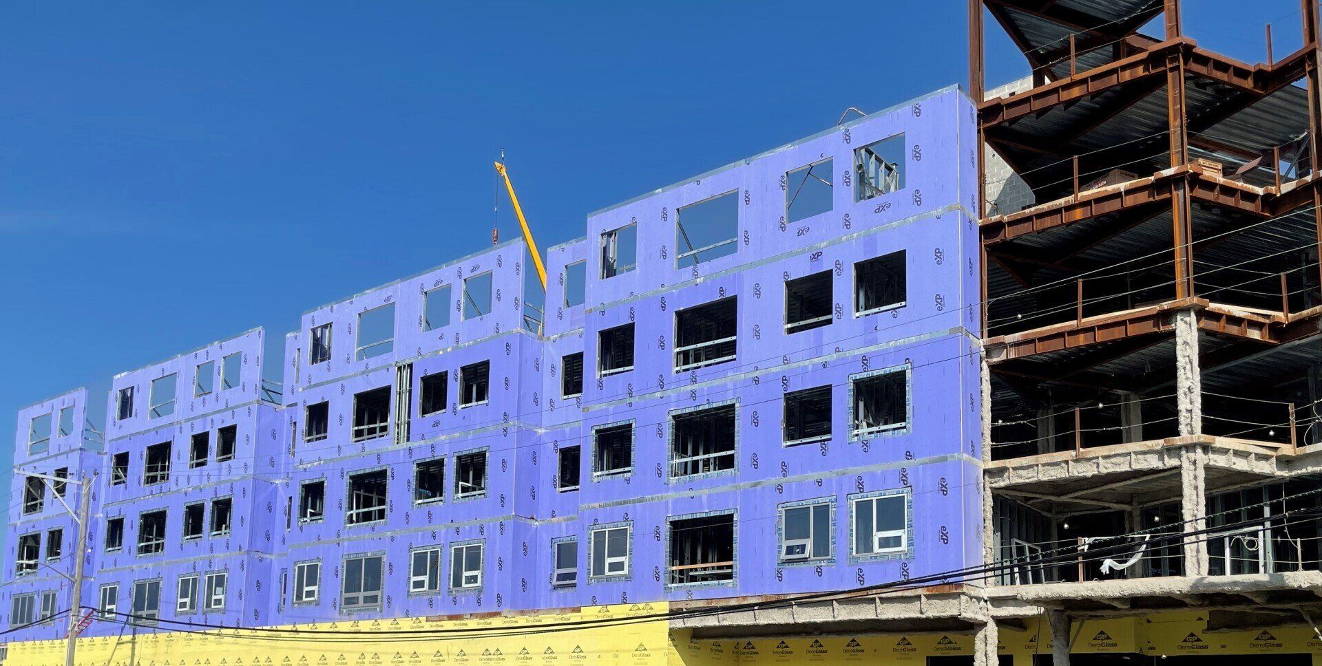 A large building under construction with a lot of windows.