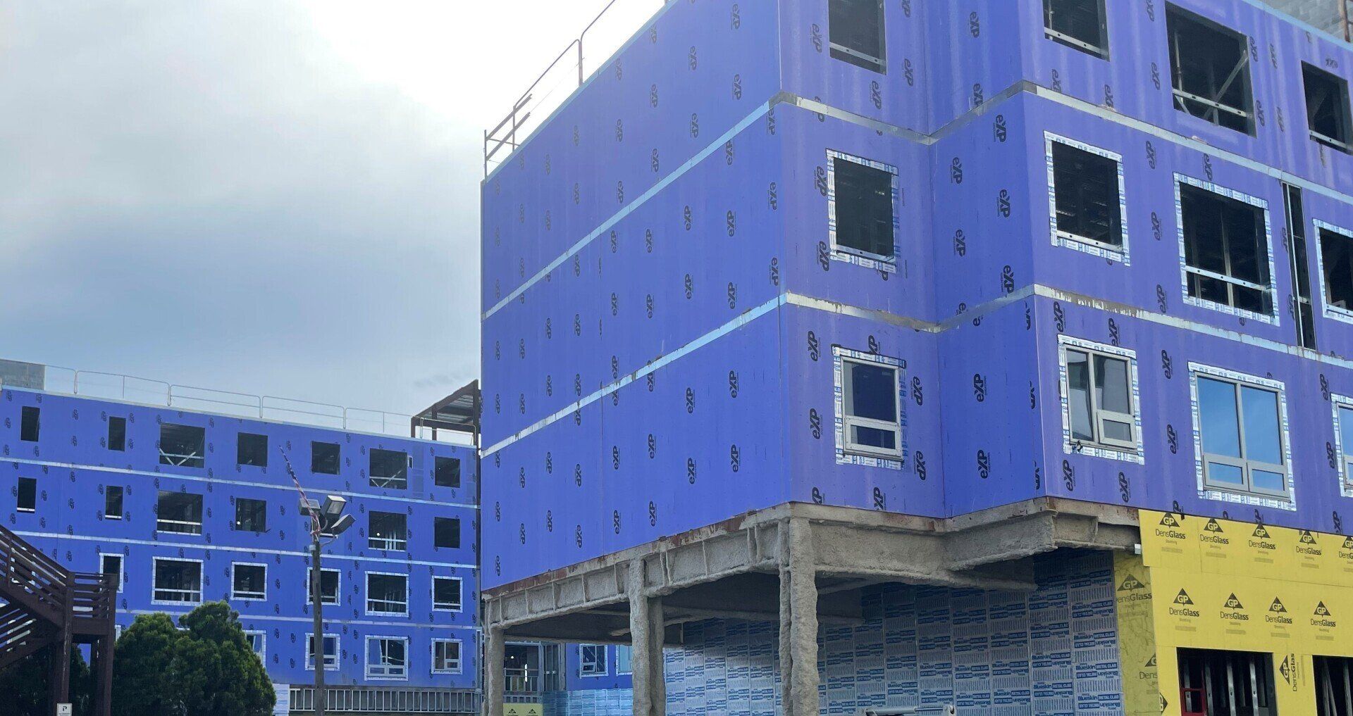 A large building is being built with a lot of windows.