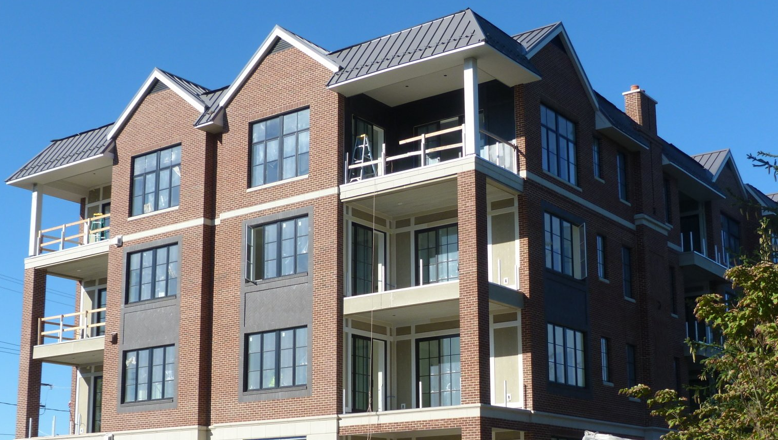 A large brick building with a blue sky in the background.