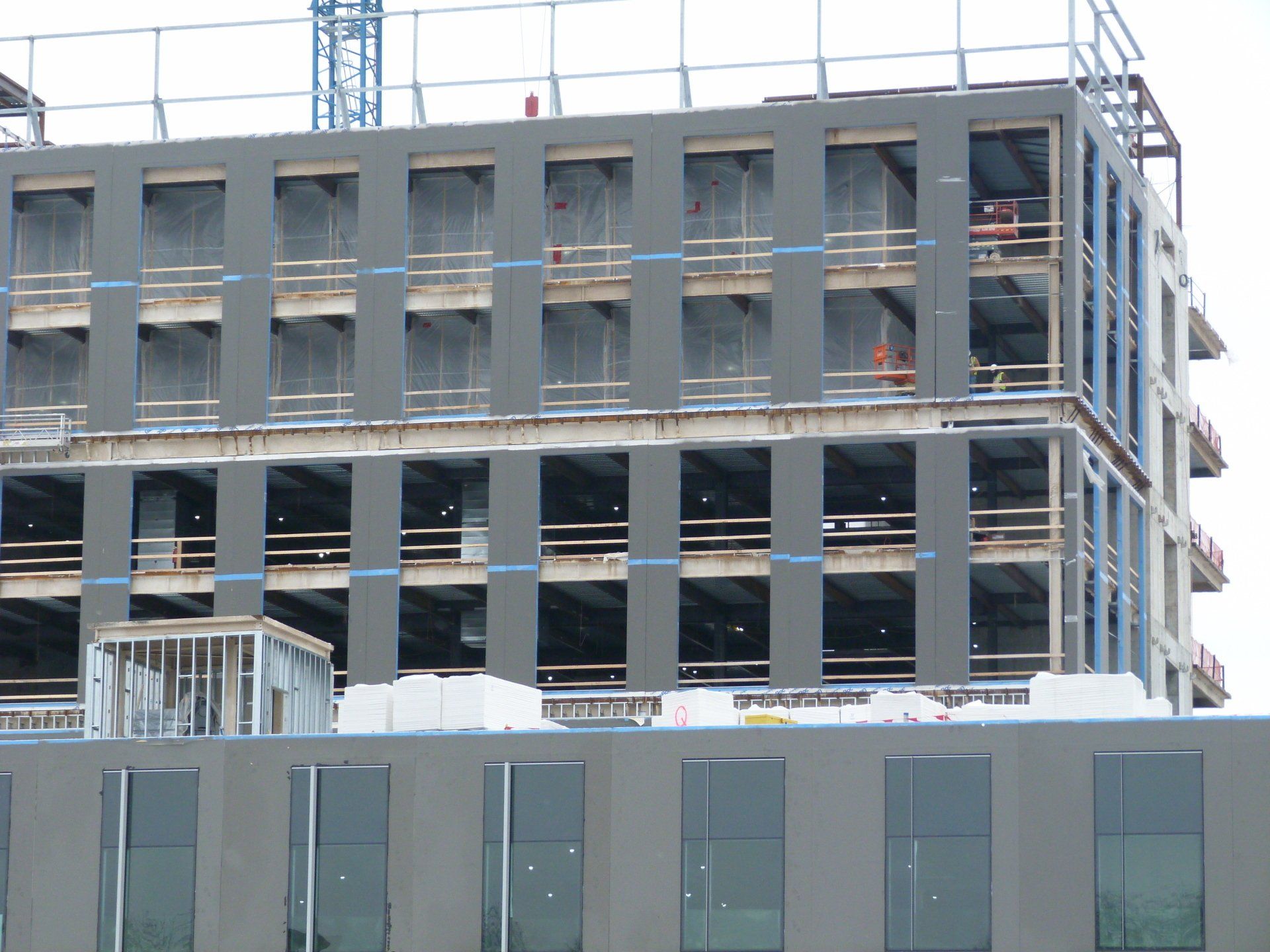A large building under construction with a lot of windows.