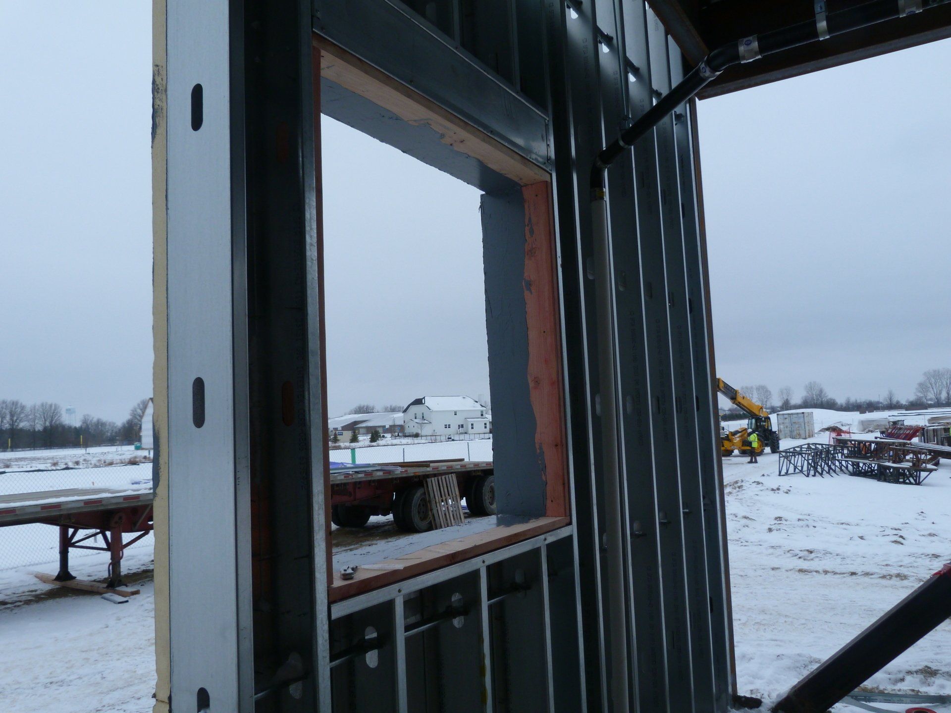 A window looking out of a building with a truck in the background.