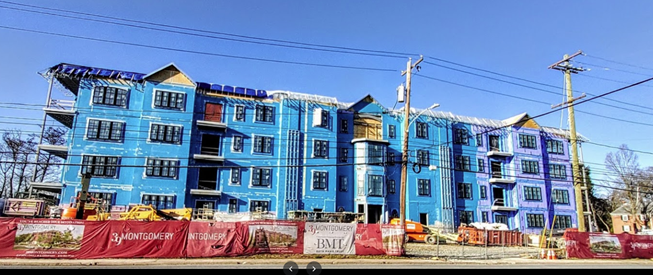 A large building is being built in the middle of a city.