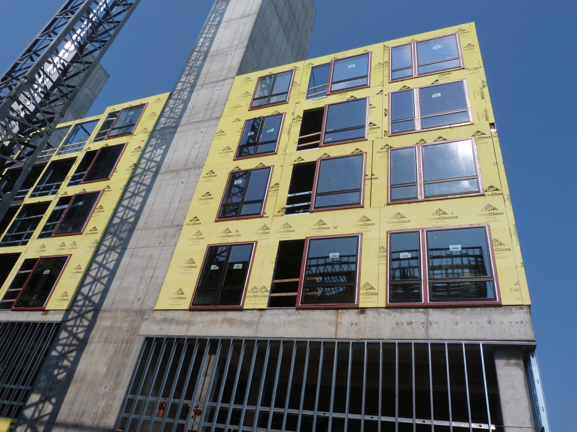 A building under construction with a crane in the background.