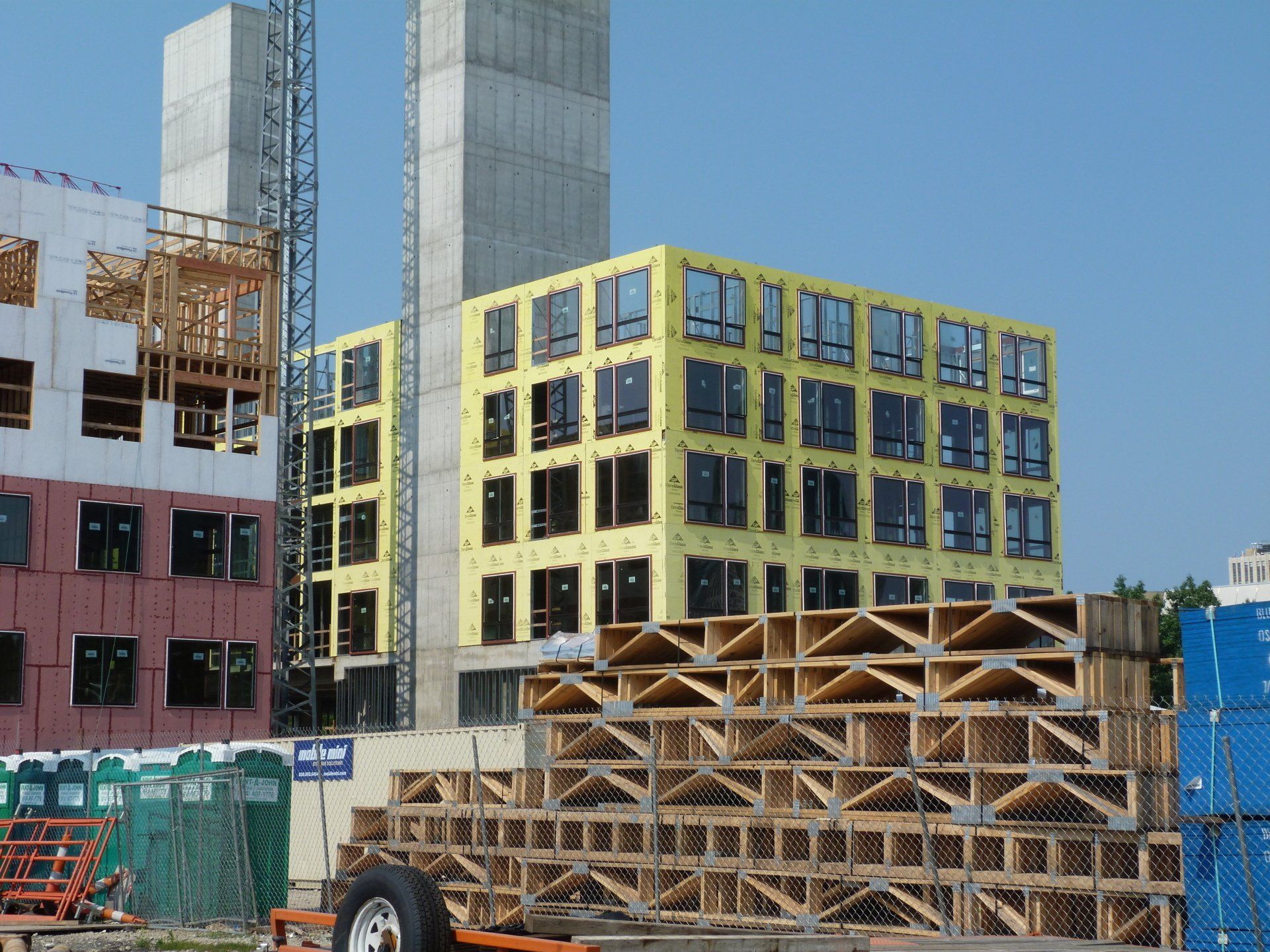 A construction site with a large building in the background.