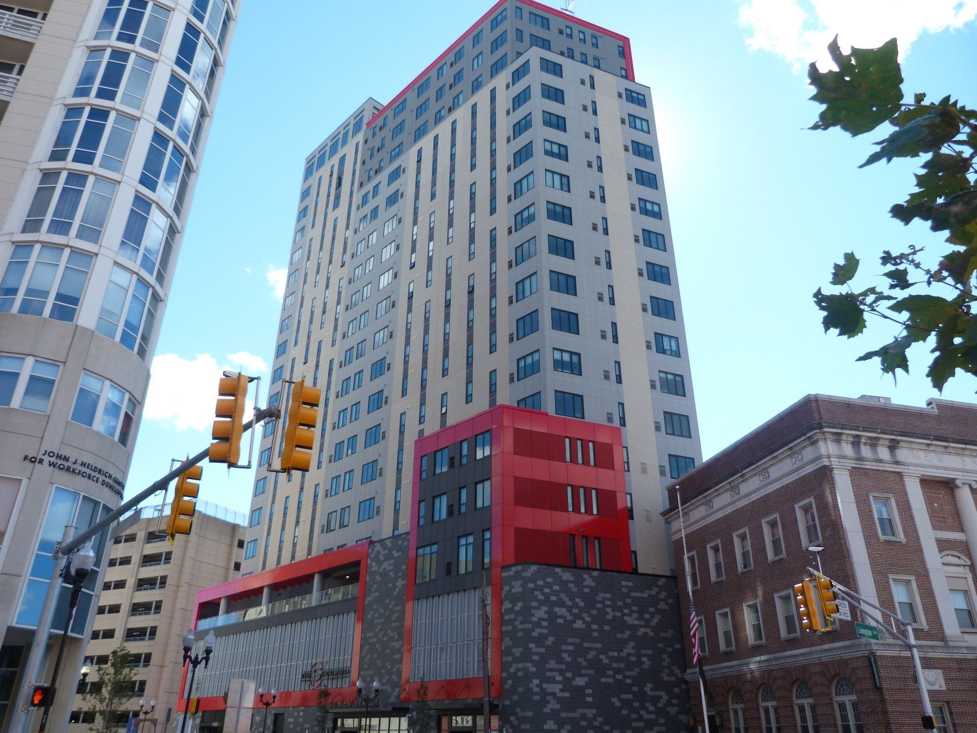 A tall building with a red stripe on the side of it.