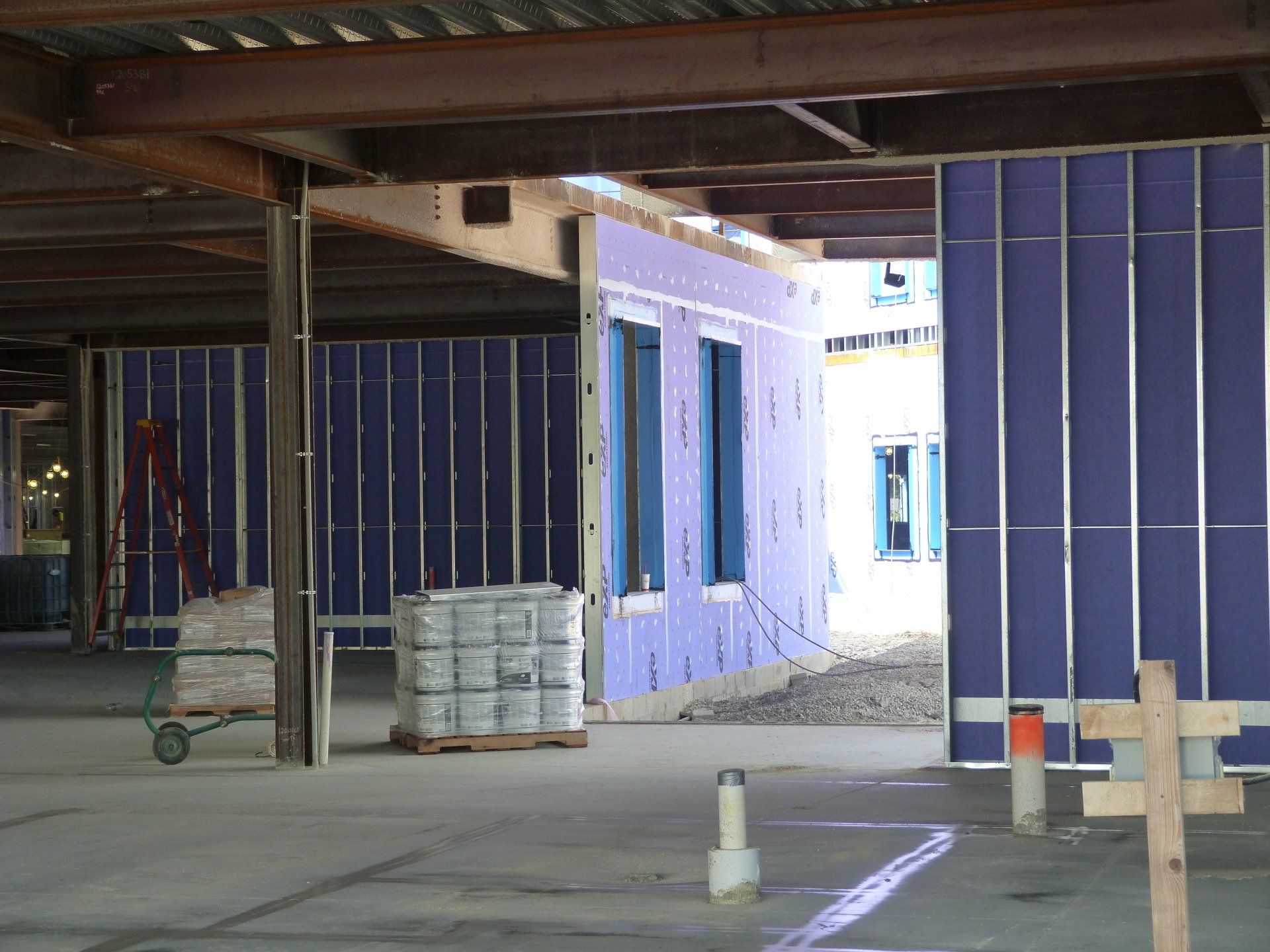 The inside of a building under construction with purple walls.