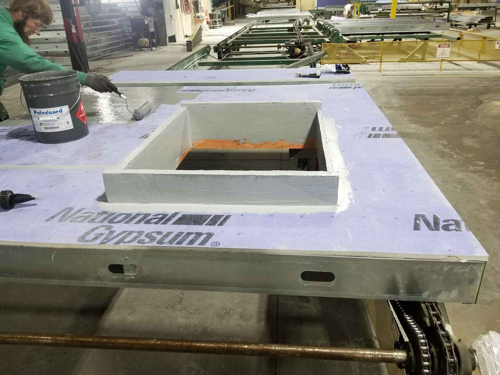 A man is working on a piece of gypsum in a factory.