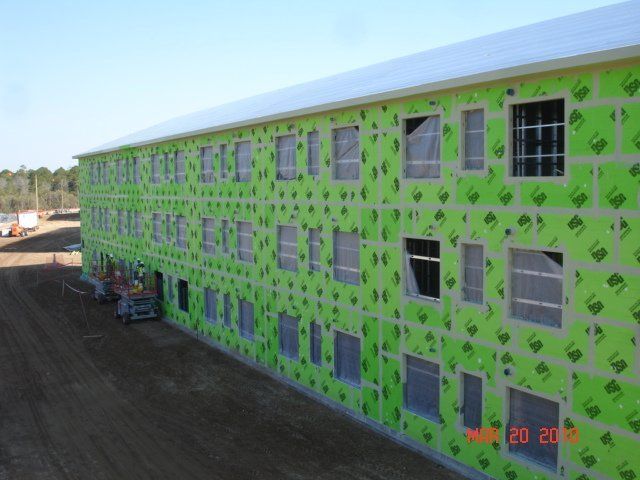 A large building with a lot of windows is being built.