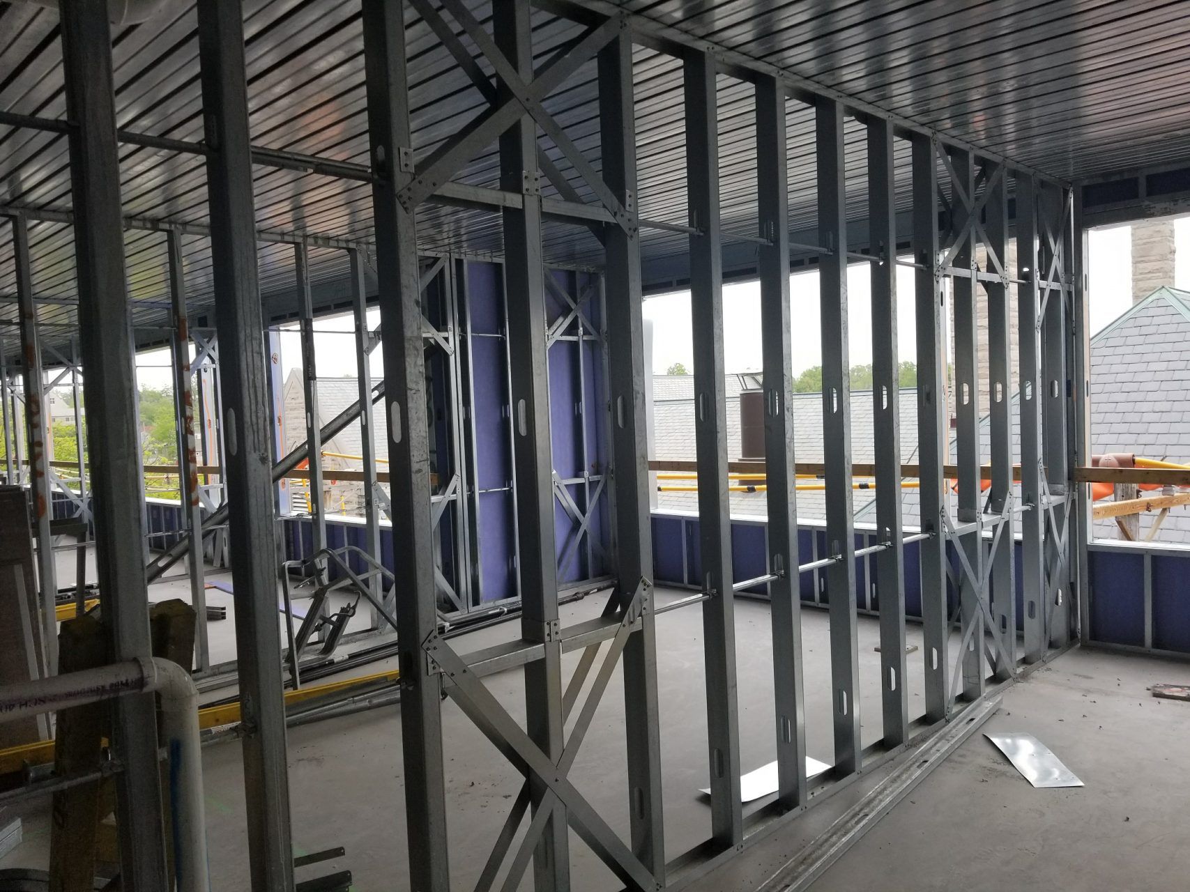 The inside of a building under construction with a lot of metal frames.