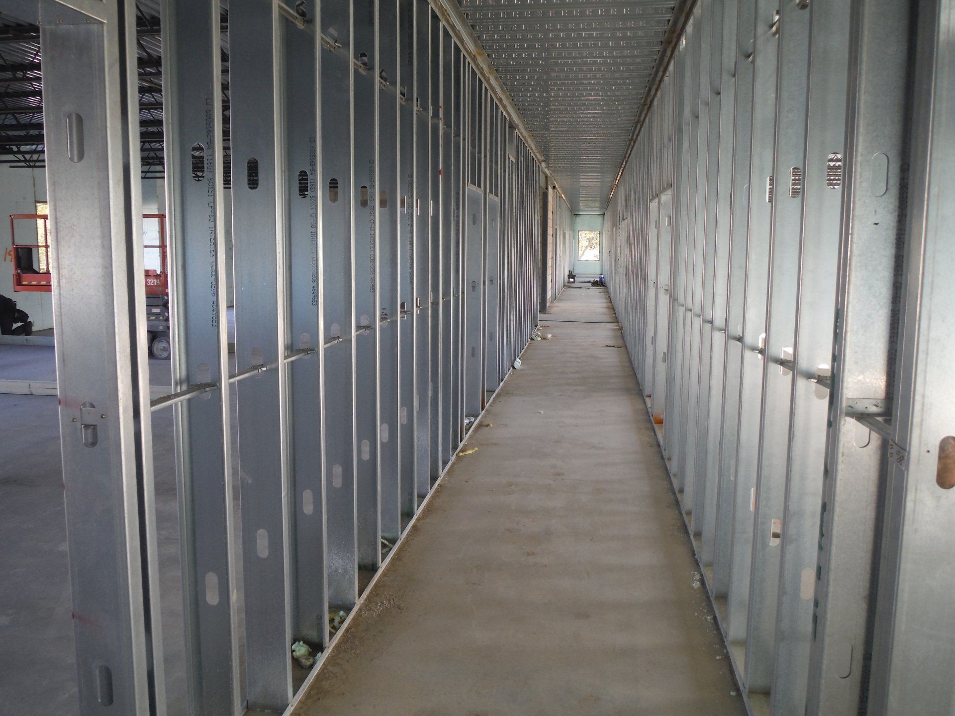 A long hallway in a building under construction.