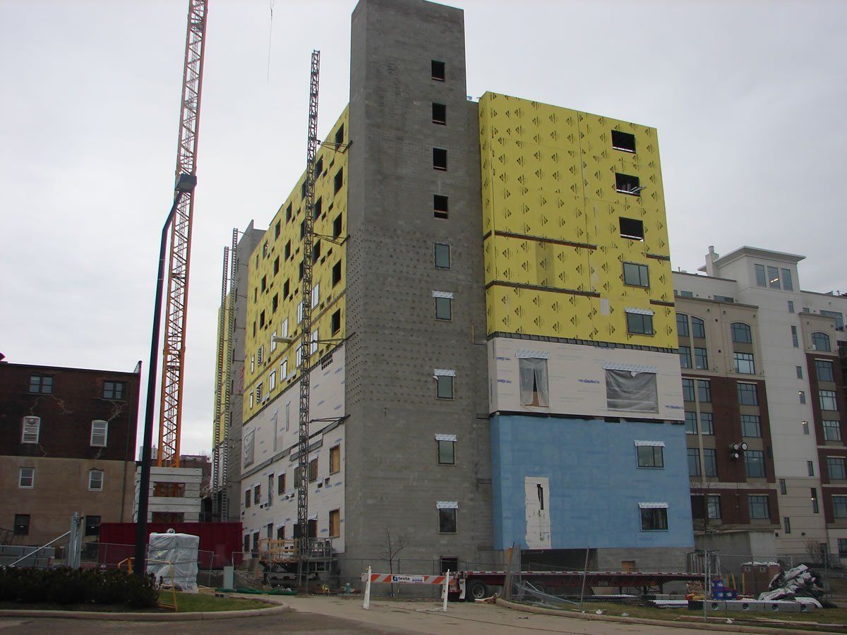 A large building under construction with a crane in the background