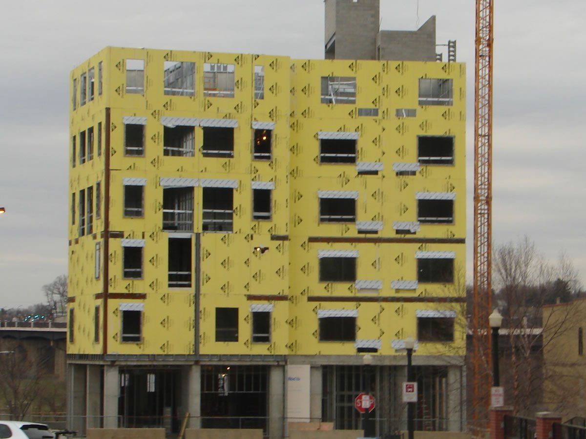A building under construction with a crane in the background.