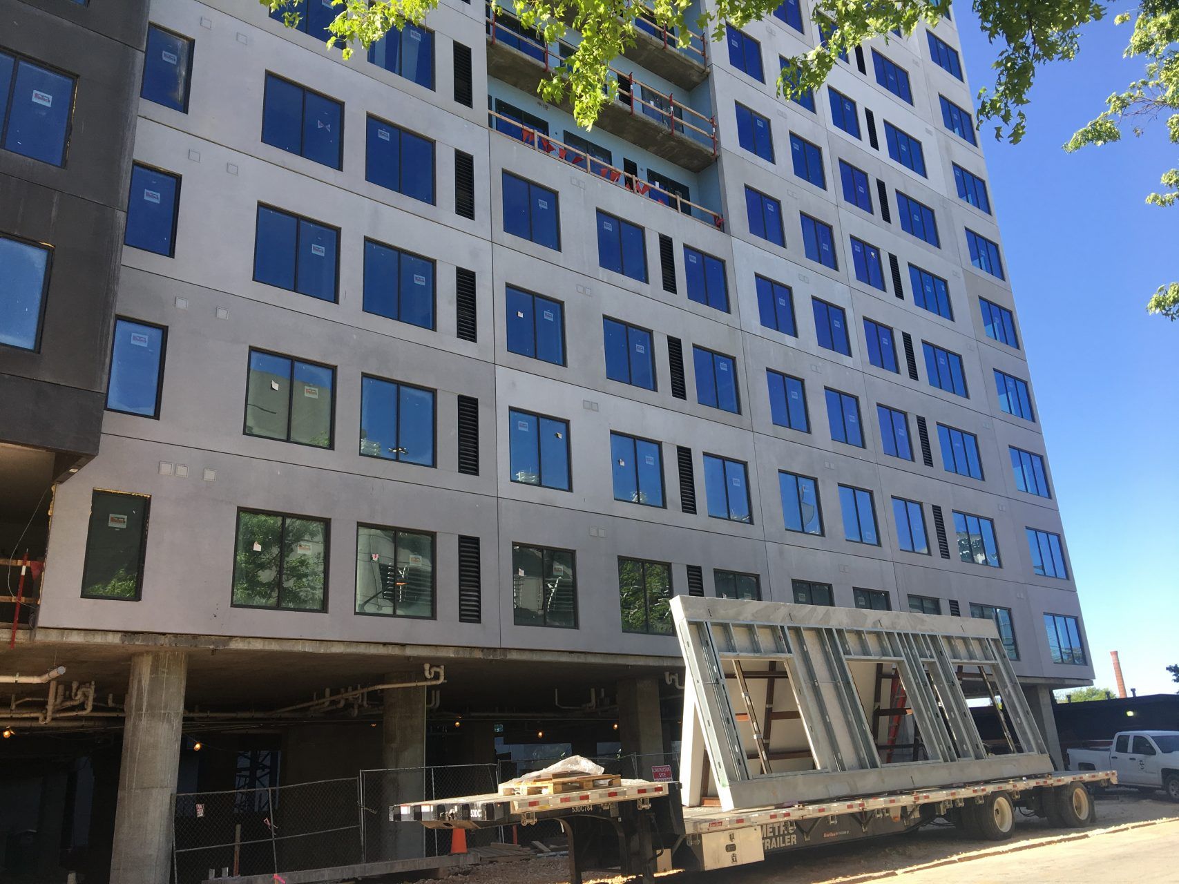 A large building under construction with a truck parked in front of it.