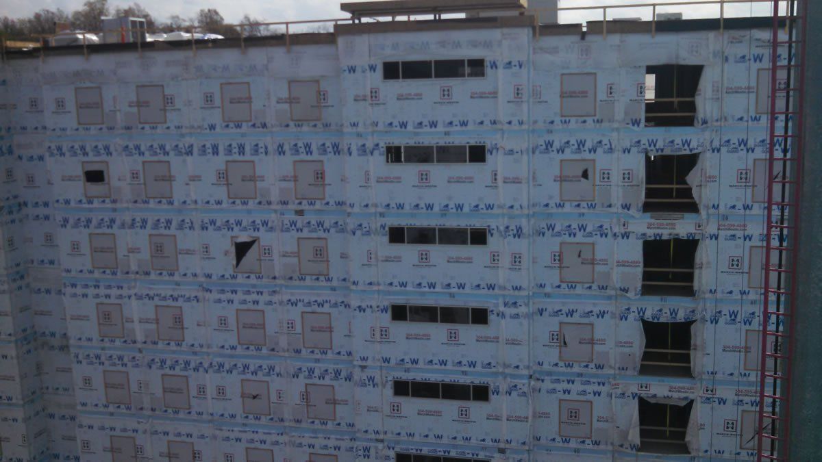 A large building under construction with a lot of windows.