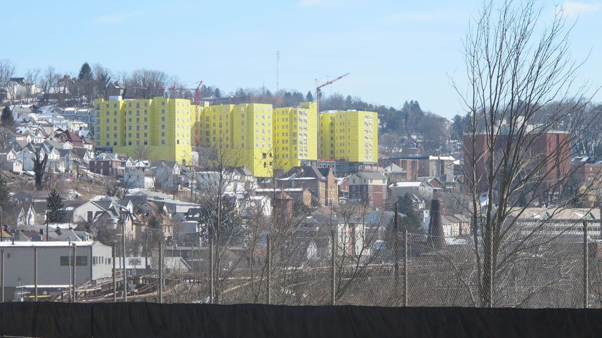 A view of a city with yellow buildings in the distance.