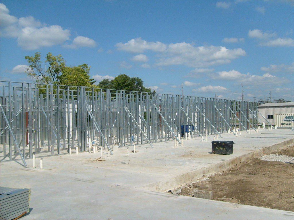 A construction site with a lot of metal frames.