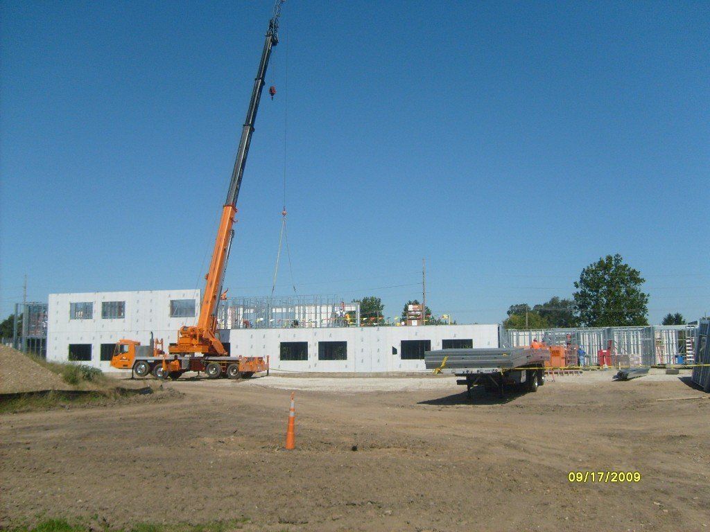 A construction site with a crane and a truck.