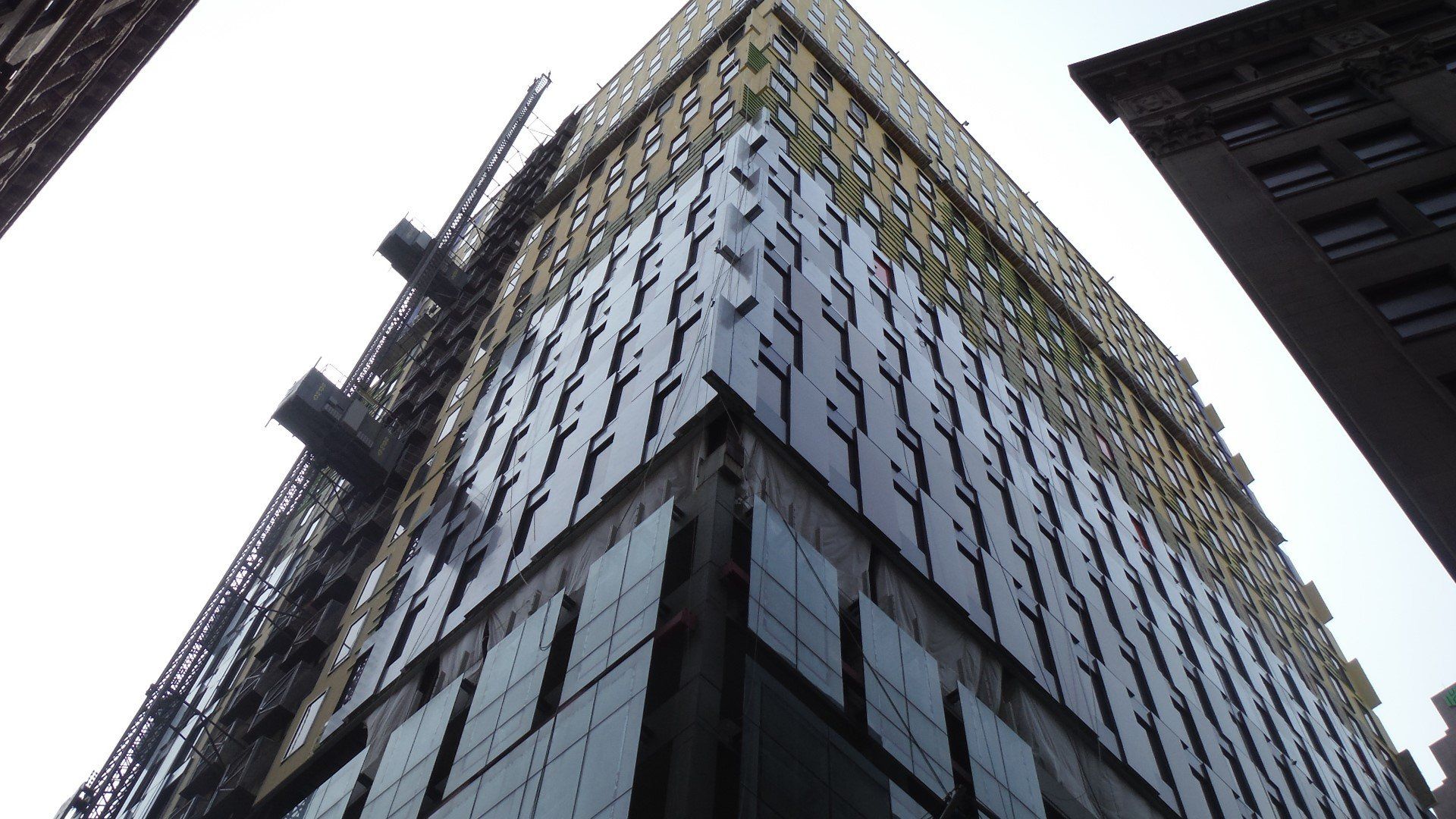 Looking up at the corner of a tall building.