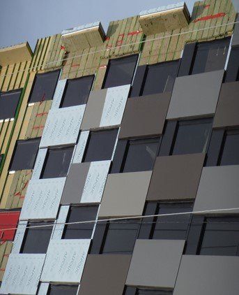 A building with a lot of windows is under construction.