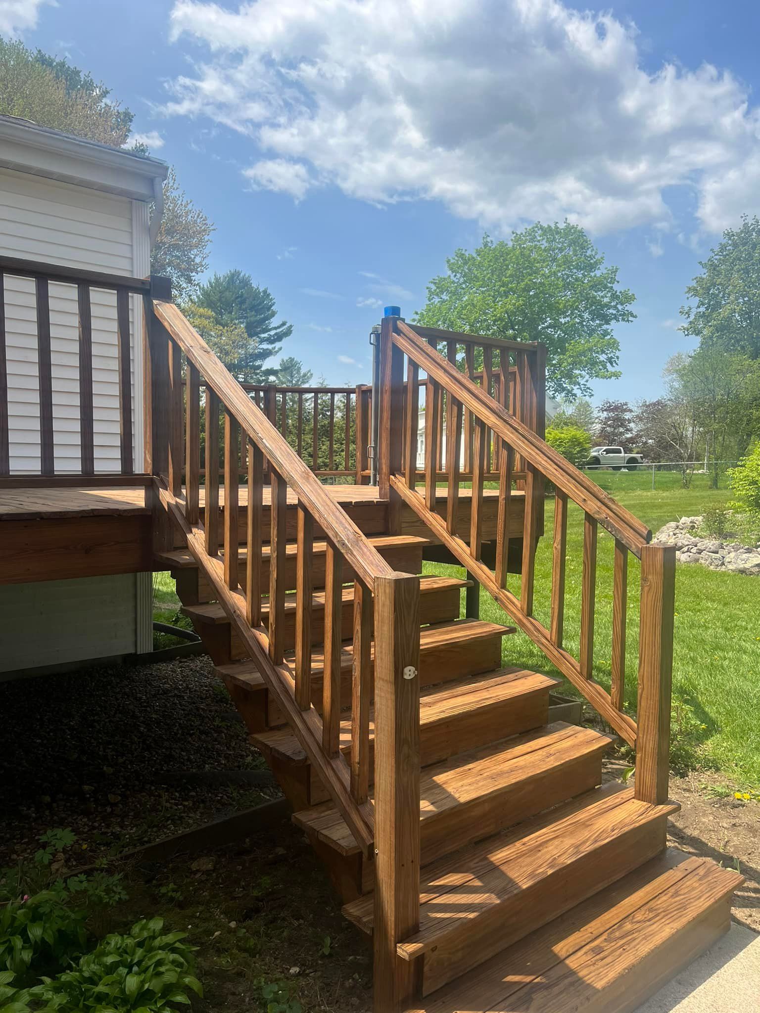 A wooden deck with stairs leading up to it.