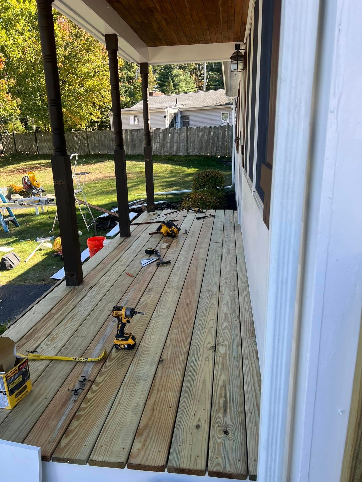 A wooden deck is being built on the side of a house.