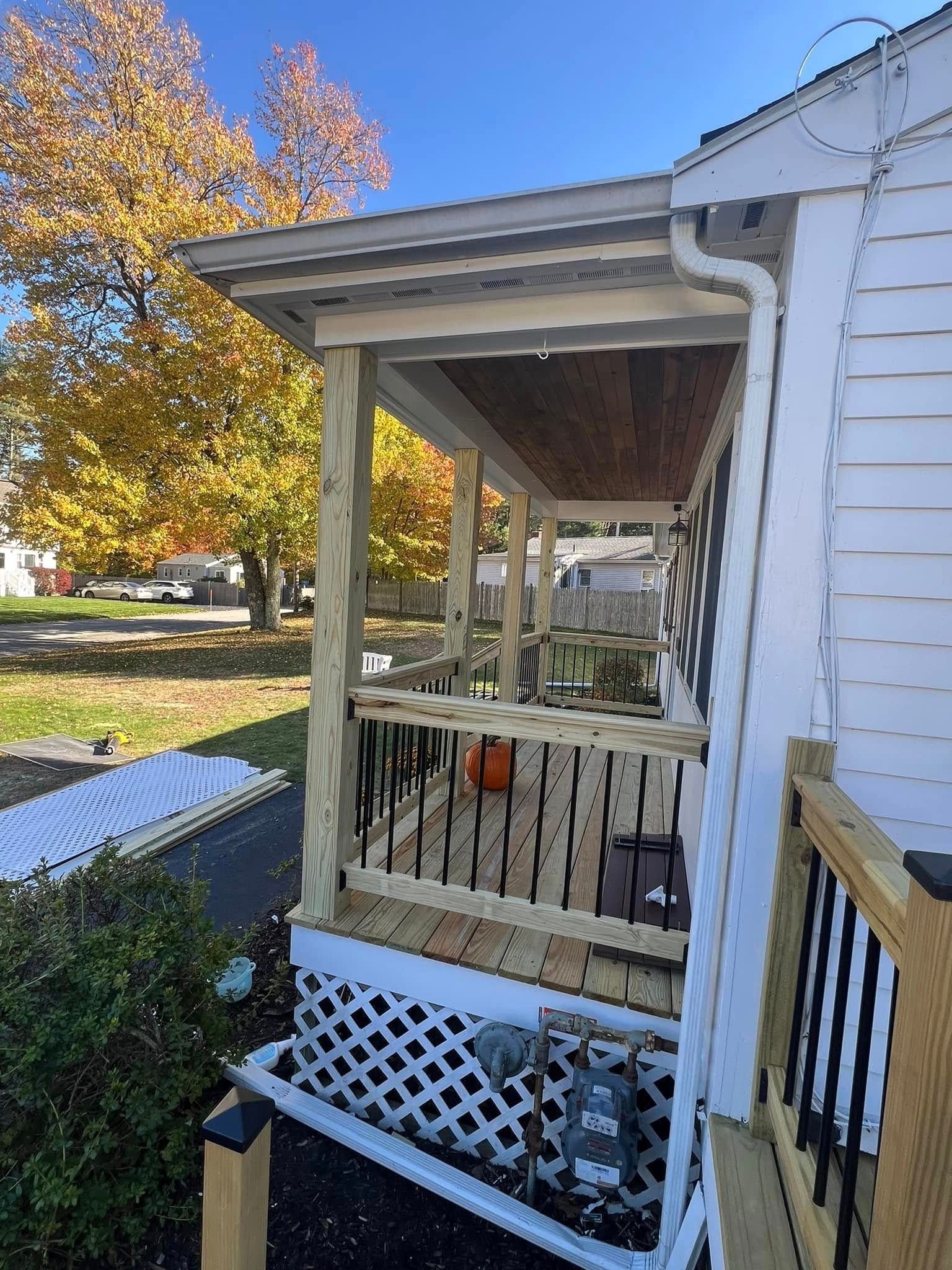 A white house with a porch and a swing on it.