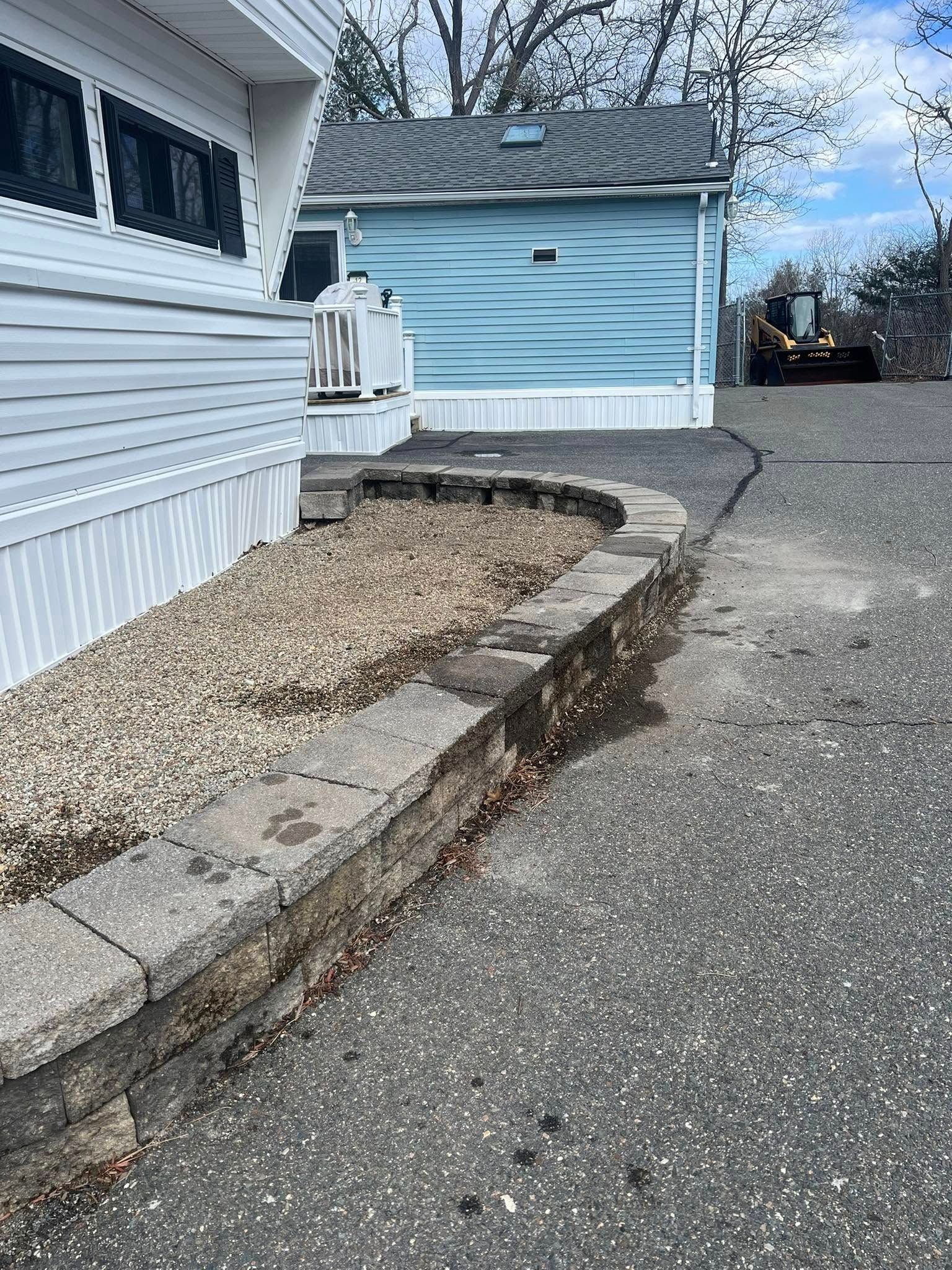 A mobile home with stairs leading up to it and a tractor in the background.