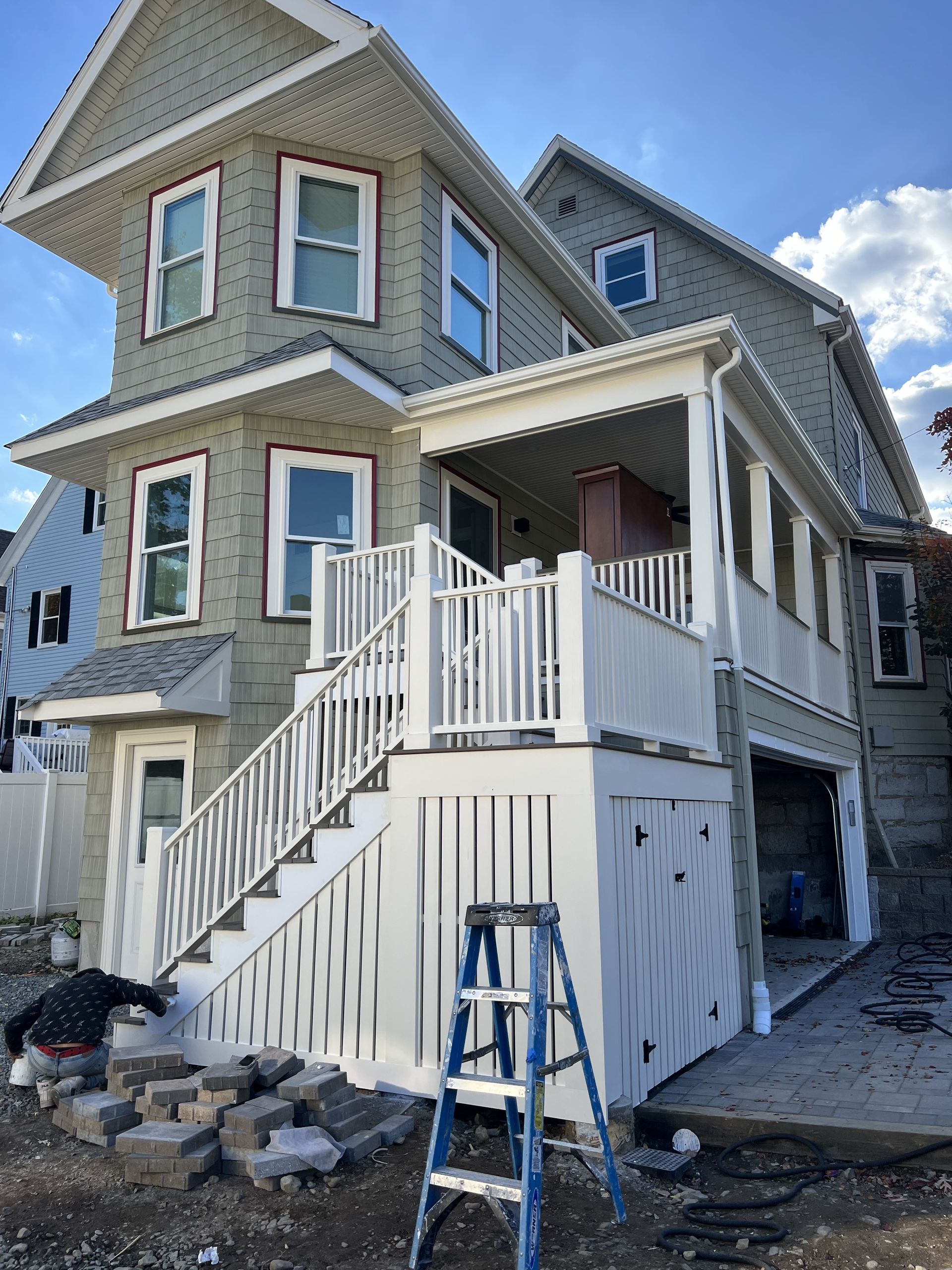 A house with stairs and a ladder in front of it