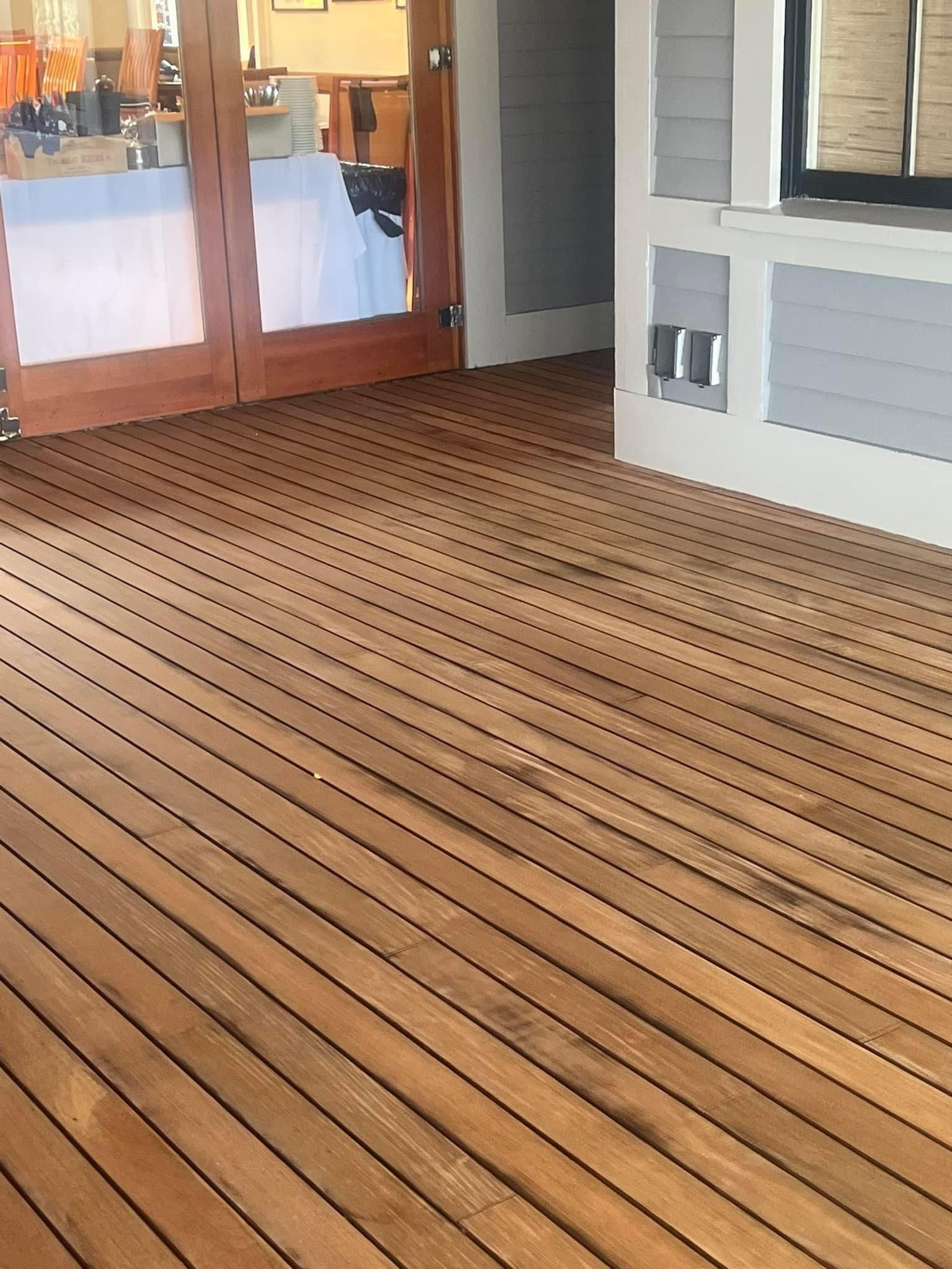 A room with a wooden floor and sliding glass doors