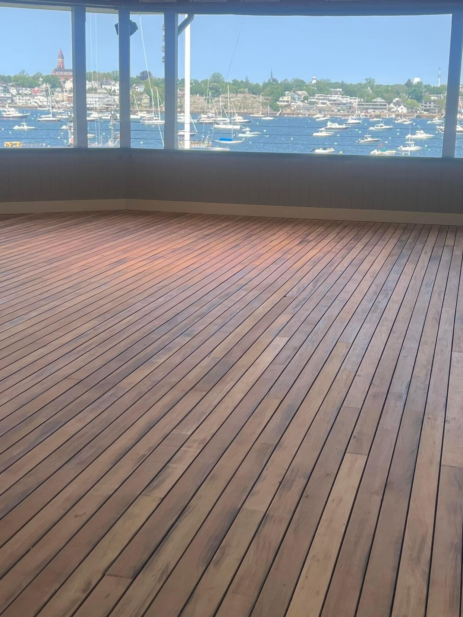 A wooden deck with a view of the ocean