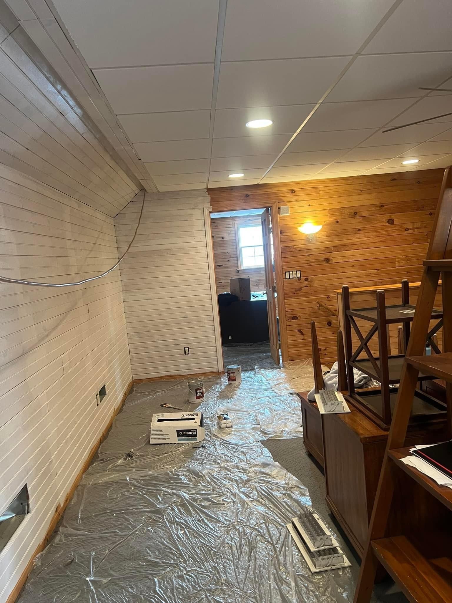 A room with a brick wall and a white ceiling is being remodeled.