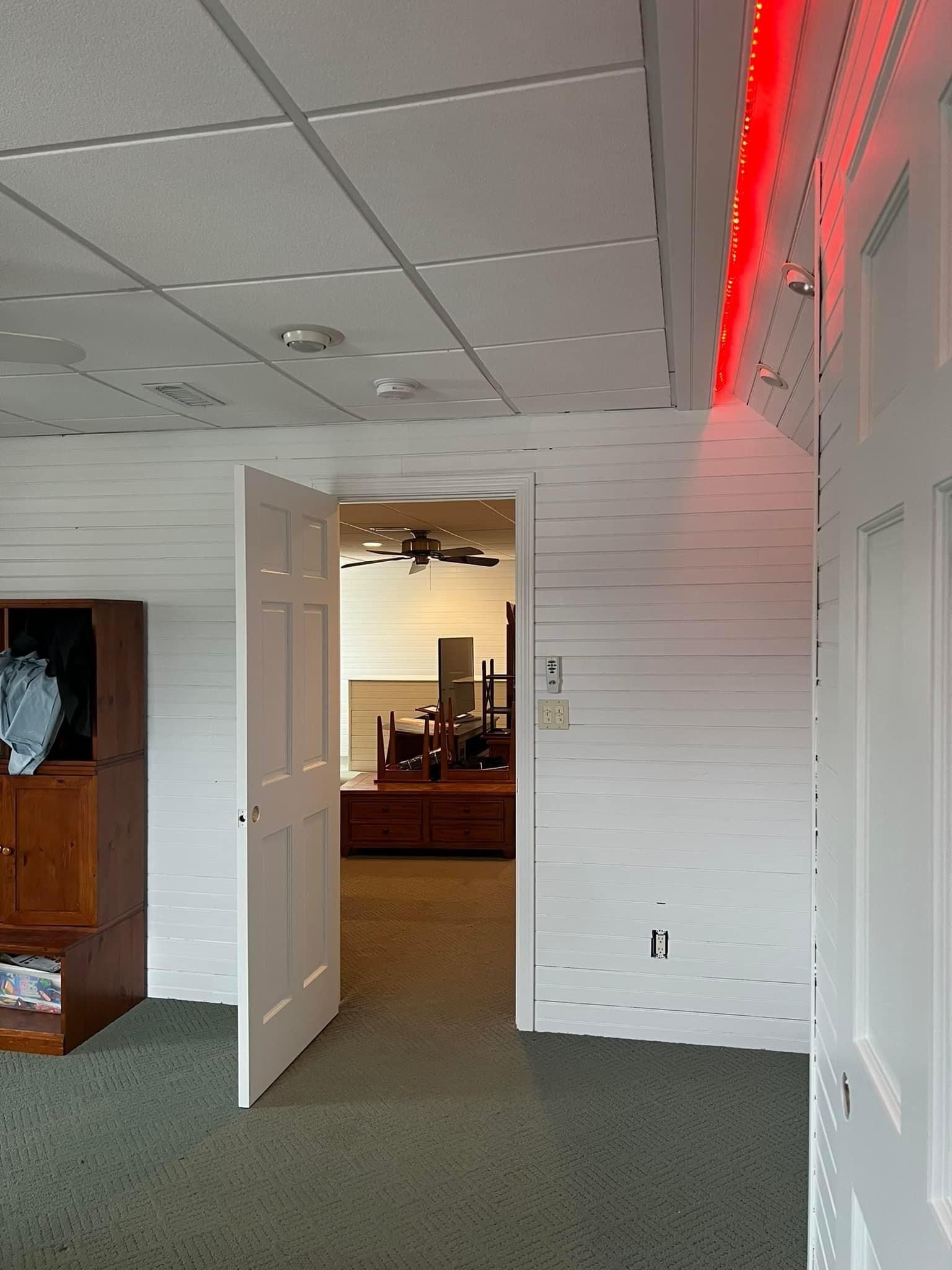 A room with white walls and a red light on the ceiling
