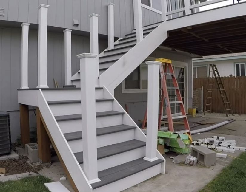 A set of stairs leading up to a deck under construction