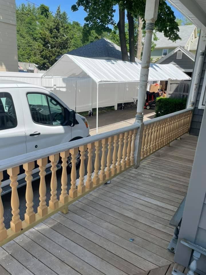A white van is parked on the porch of a house.