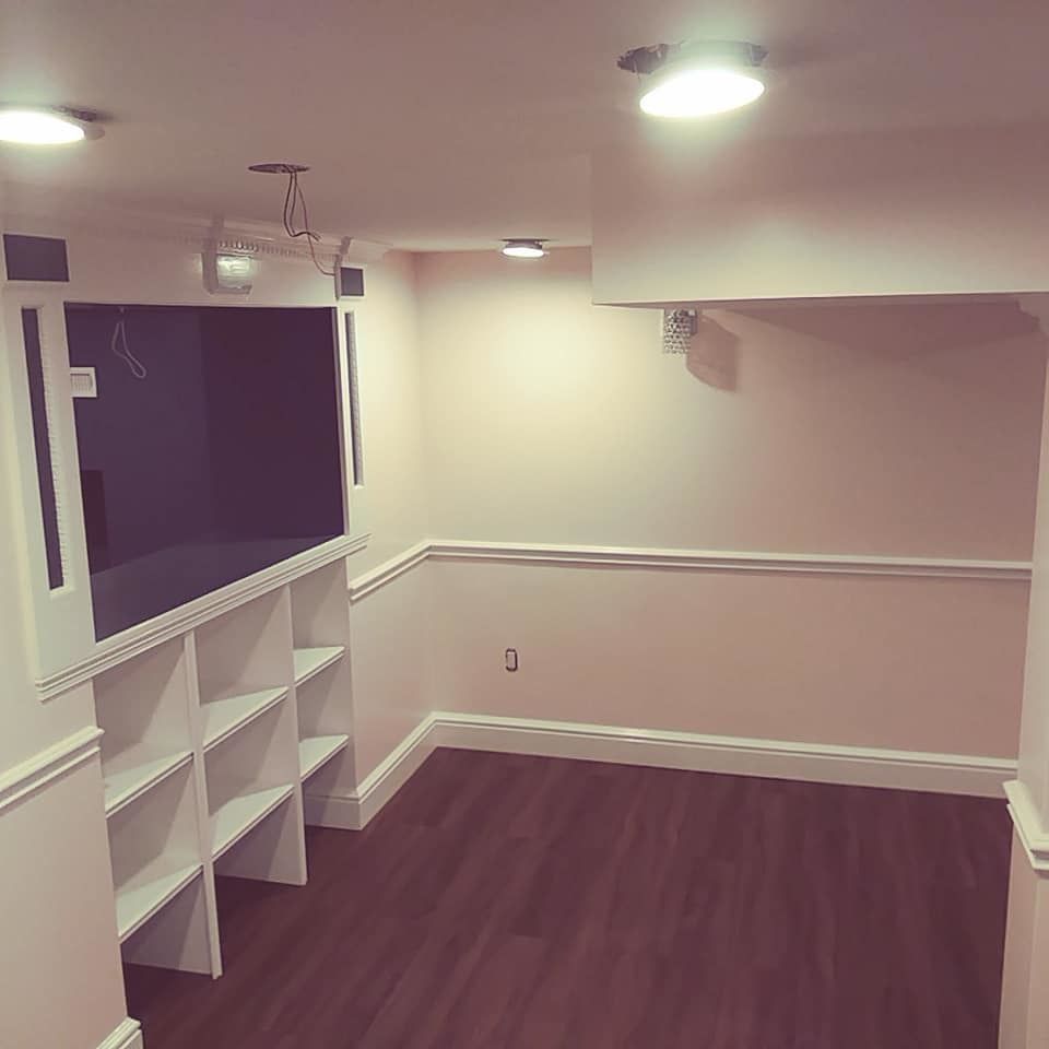 A room with hardwood floors and white shelves