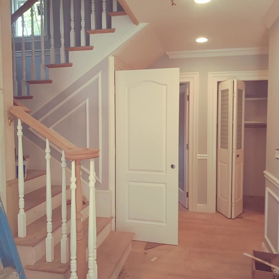 A hallway with stairs leading up to the second floor