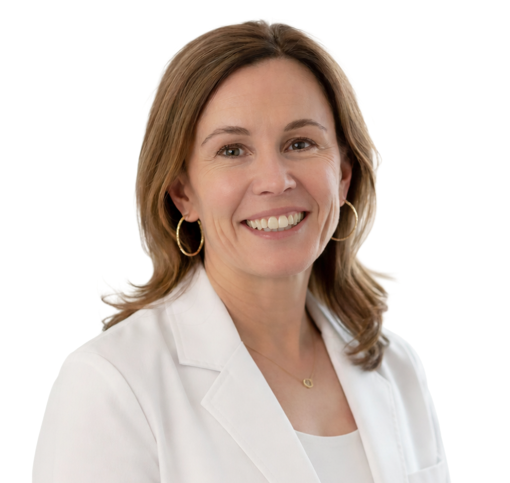 Woman in a white coat smiling, wearing gold hoop earrings, and a small necklace.