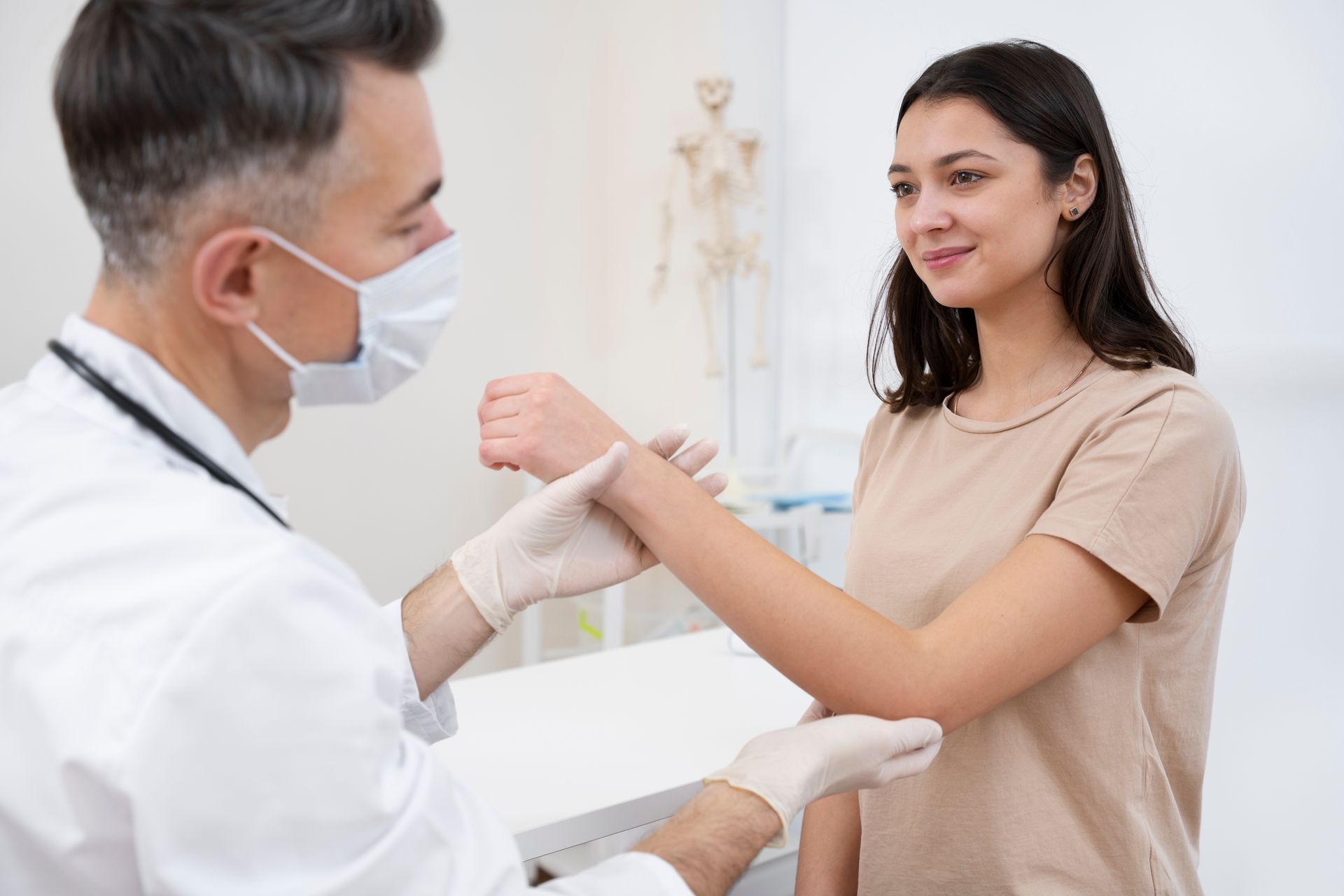 Woman at a cosmetic clinic. A doctor in blue gloves examines her face with a mirror, white setting.