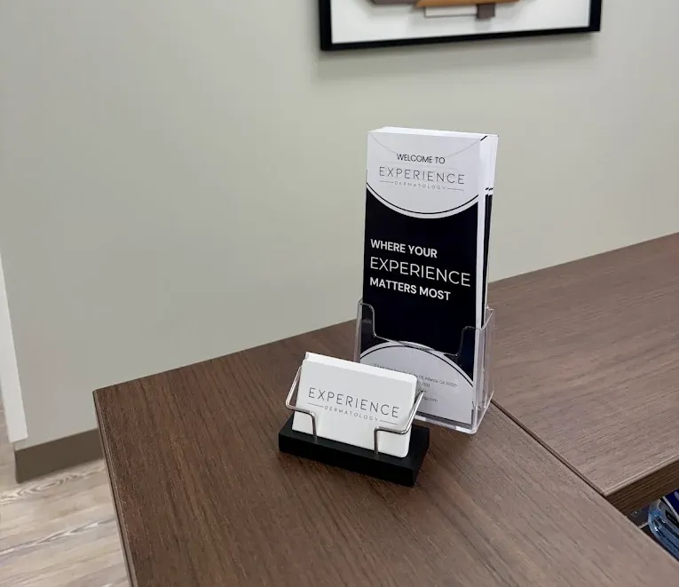 Tabletop brochure display with black-and-white “Experience” pamphlets in an office setting