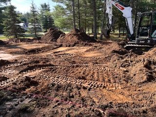 A bulldozer is digging a hole in the dirt.