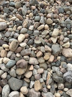 A pile of rocks sitting on top of each other on the ground.