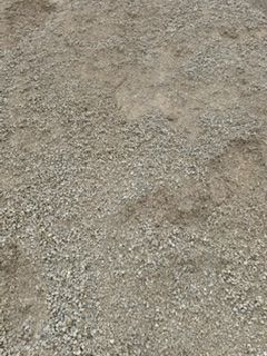 A pile of gravel is sitting on the ground.