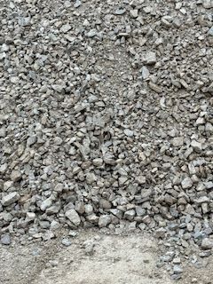 A pile of gravel is sitting on the ground.