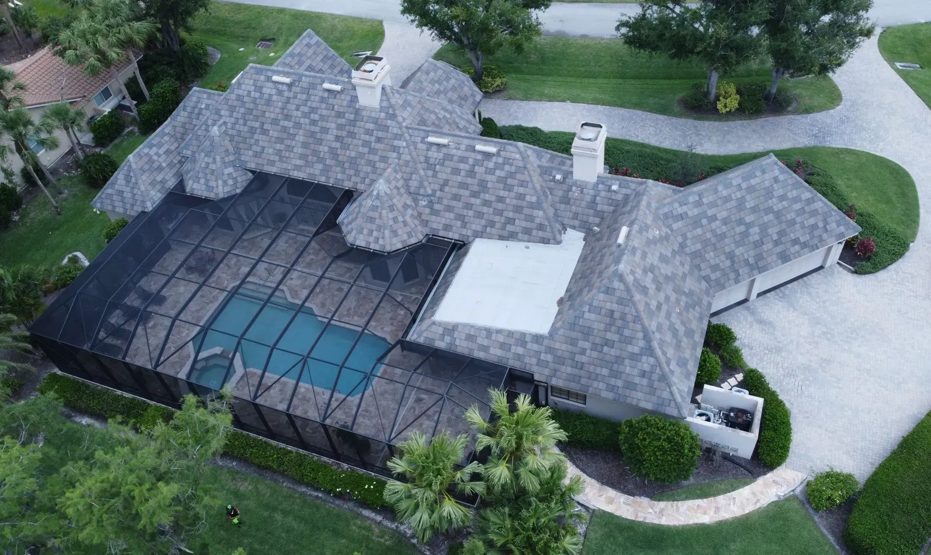 An aerial view of a house with a swimming pool.