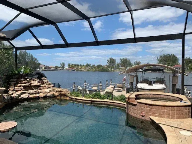 A large swimming pool with a boat in the background