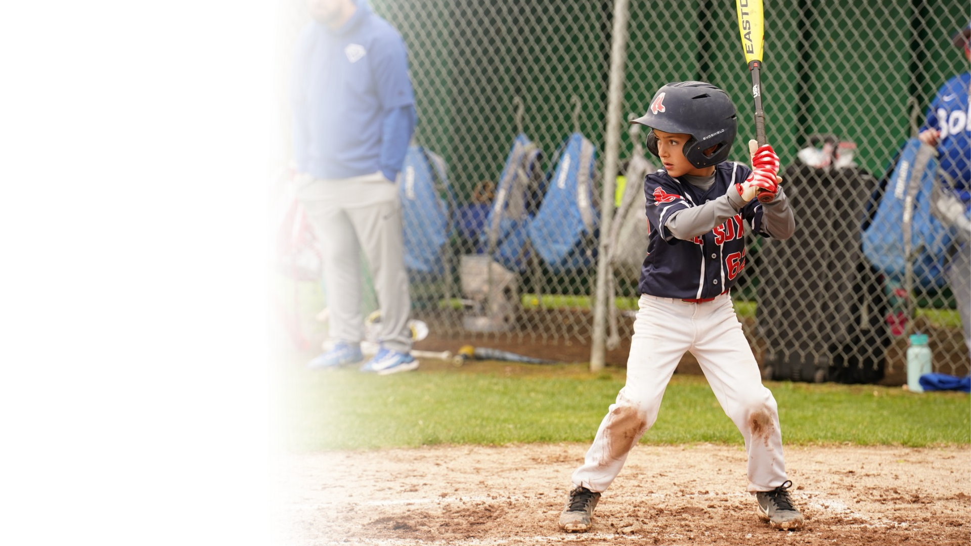 A young baseball player stands at home plate.