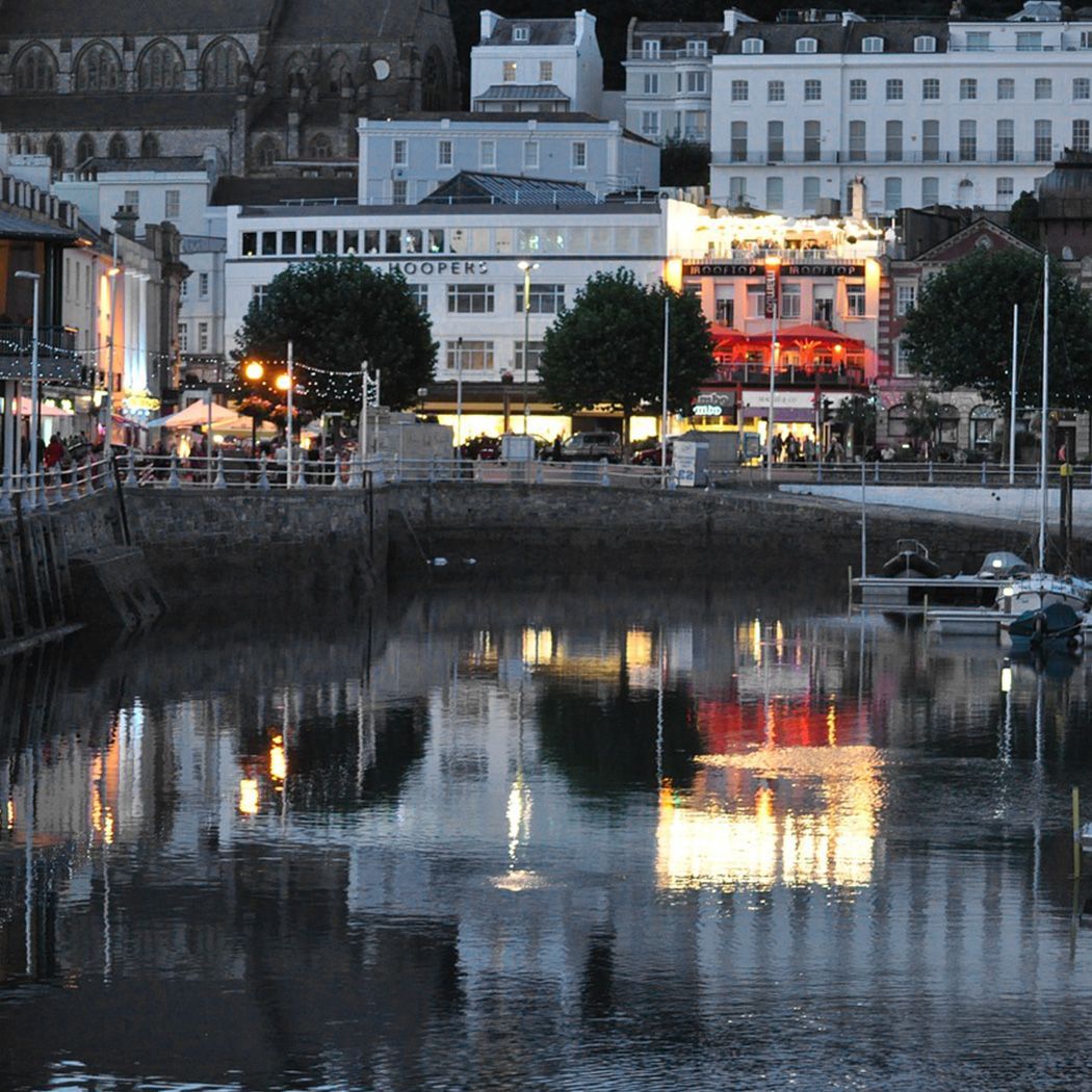 A reflection of a city in a body of water