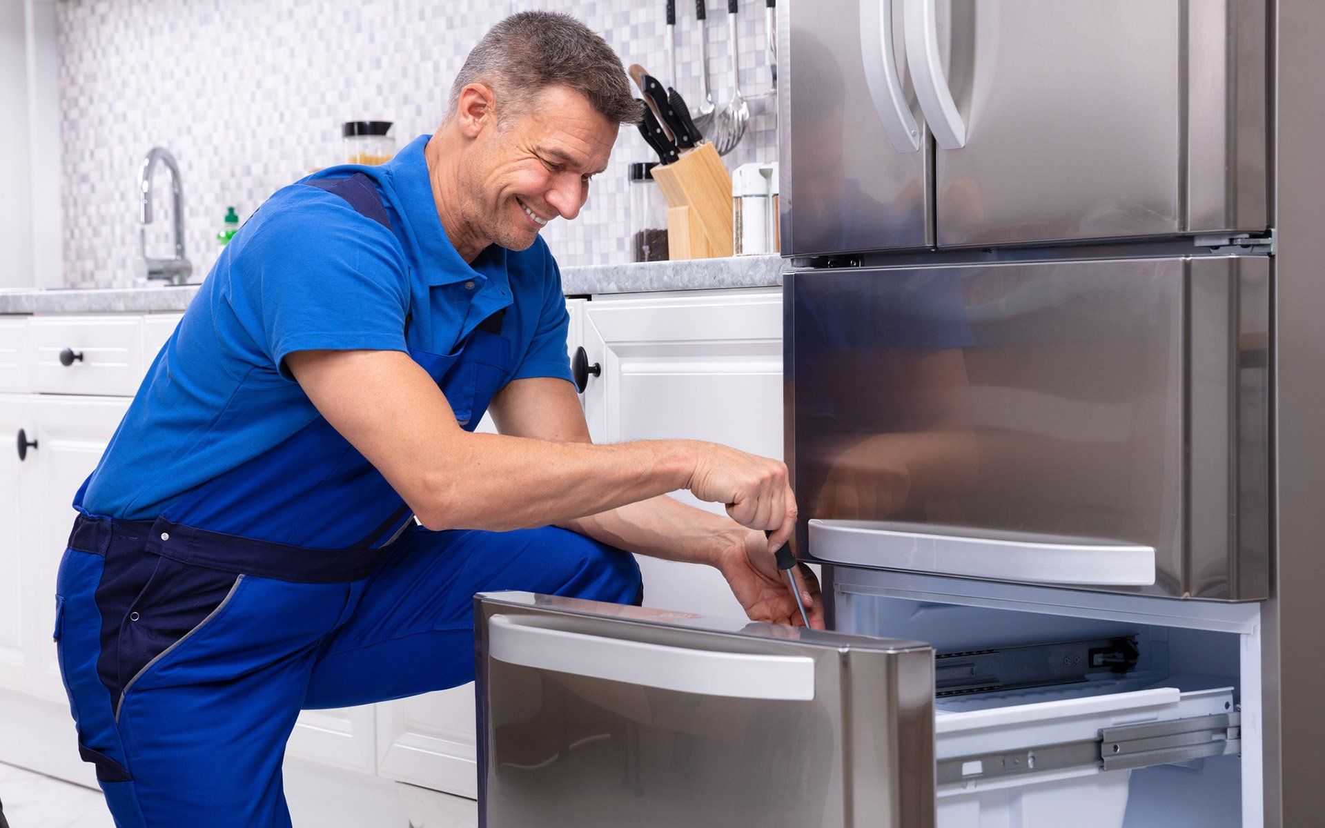 Worker Fixing Refrigerator — Fairdale, KY — A + Appliance Repair