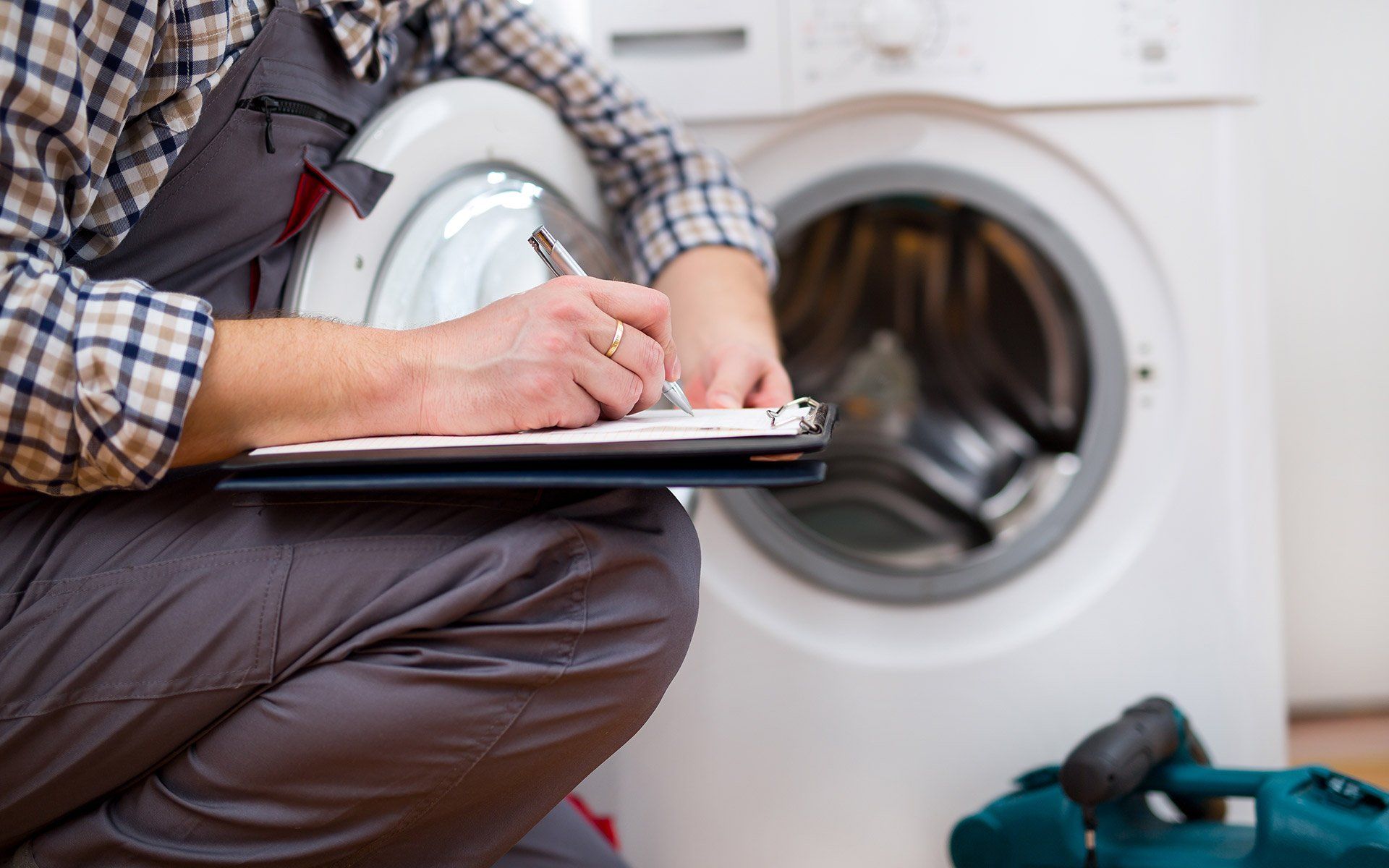 Worker Writing Notes — Fairdale, KY — A + Appliance Repair