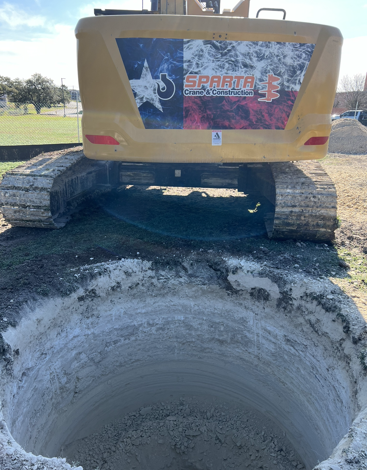 A large excavator is digging a hole in the ground.